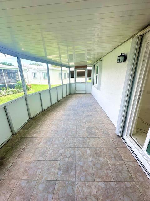 unfurnished sunroom featuring wood ceiling