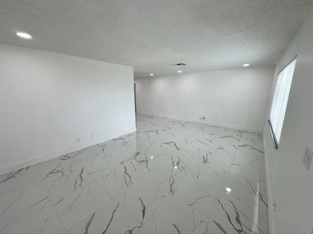 spare room featuring a textured ceiling