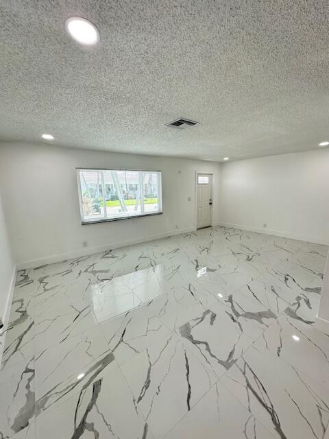 spare room featuring a textured ceiling