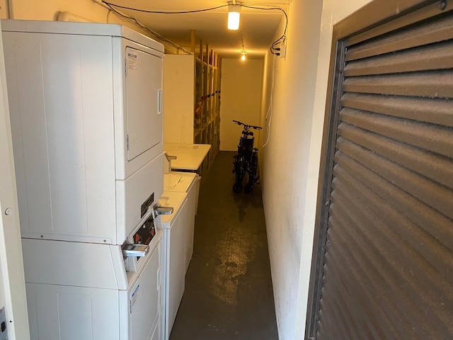 basement featuring stacked washer and clothes dryer