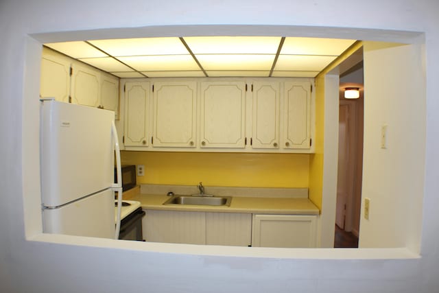 kitchen featuring sink and white appliances