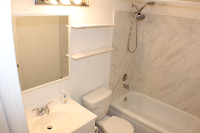 full bathroom with vanity, tiled shower / bath, and toilet