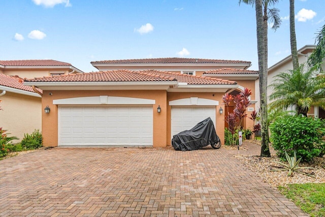 garage with decorative driveway