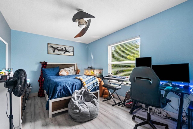 bedroom with ceiling fan and wood finished floors