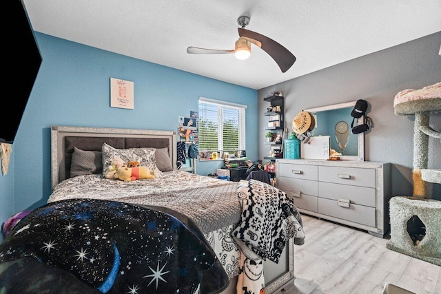 bedroom with a ceiling fan and wood finished floors