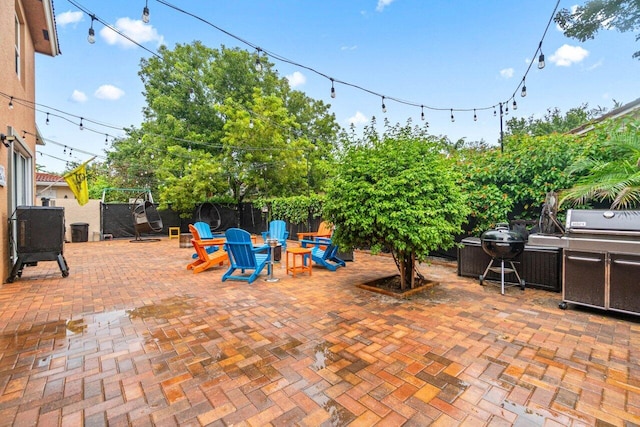 view of patio / terrace featuring fence and a grill