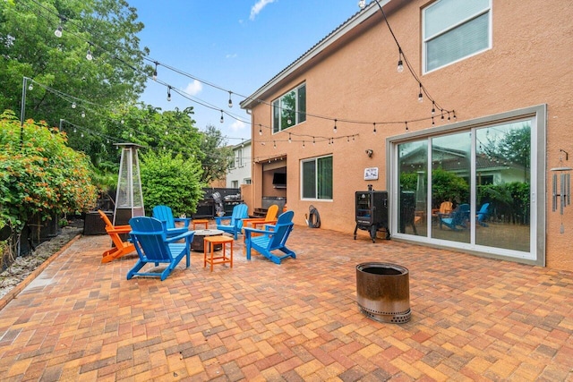 view of patio with a fire pit and fence