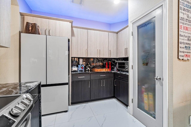 kitchen with visible vents, freestanding refrigerator, stainless steel range with electric stovetop, marble finish floor, and a toaster