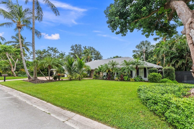 single story home featuring a front lawn