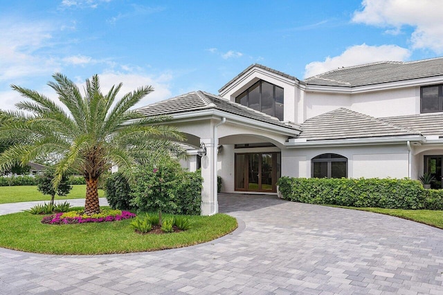 view of front of house featuring french doors and a front yard