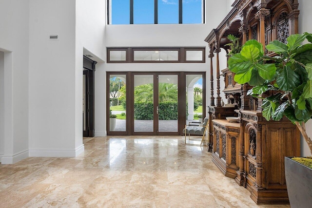 foyer entrance with a towering ceiling