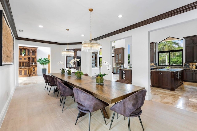 dining area featuring an inviting chandelier and ornamental molding