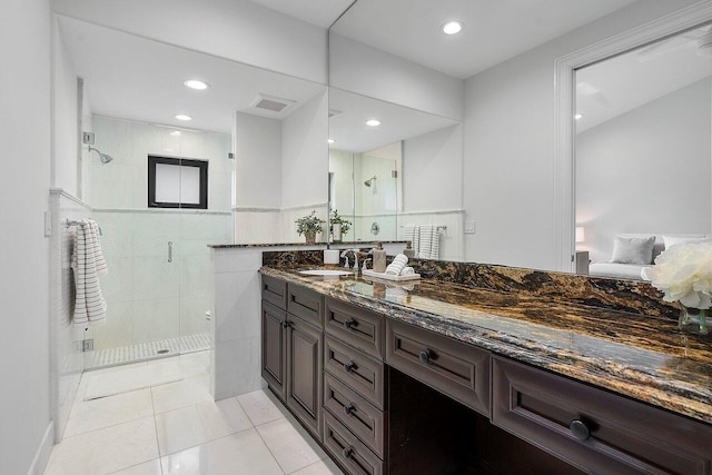 bathroom with vanity, tile patterned floors, and a shower with shower door