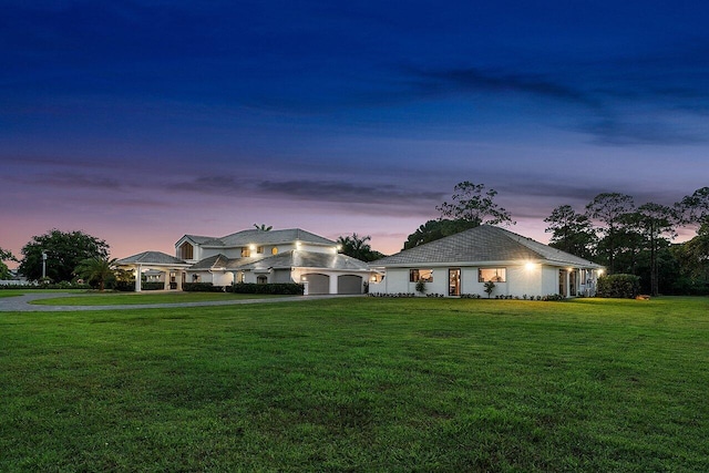 view of front of house featuring a garage and a yard