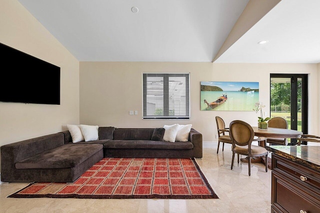 living room featuring lofted ceiling and french doors