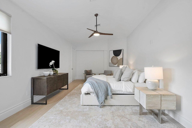 bedroom with light hardwood / wood-style floors and ceiling fan