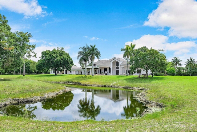 view of home's community featuring a water view and a yard