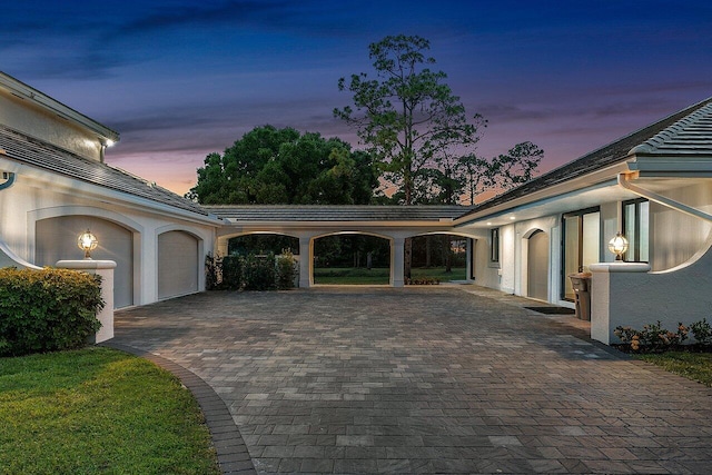 property exterior at dusk featuring a garage