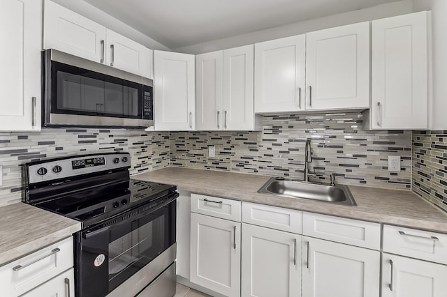 kitchen with appliances with stainless steel finishes, white cabinetry, and decorative backsplash