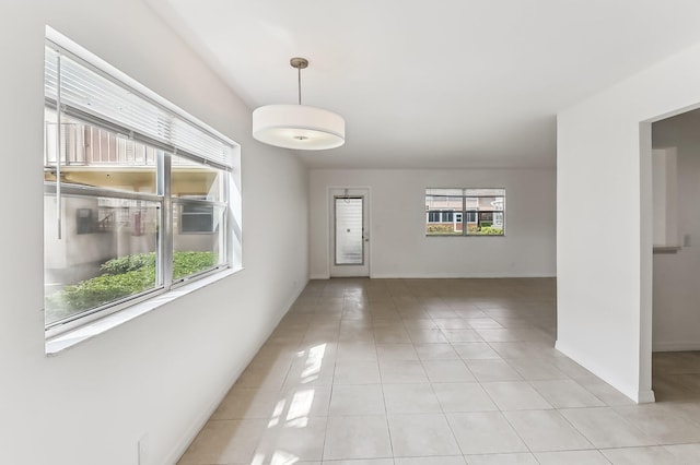 tiled spare room featuring a wealth of natural light