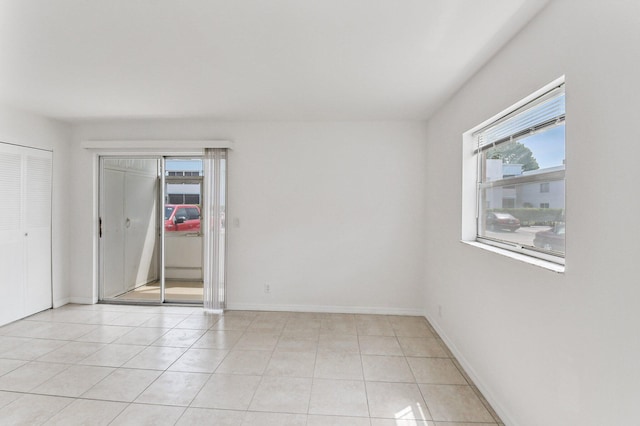 spare room featuring light tile patterned floors