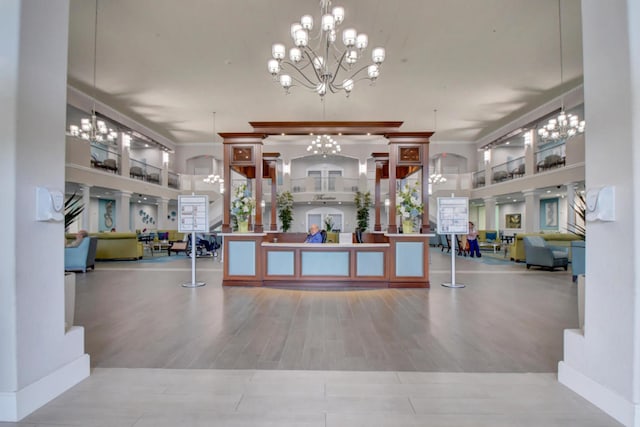 welcome area with decorative columns and a chandelier