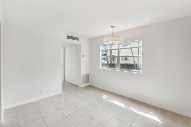 empty room with light tile patterned flooring