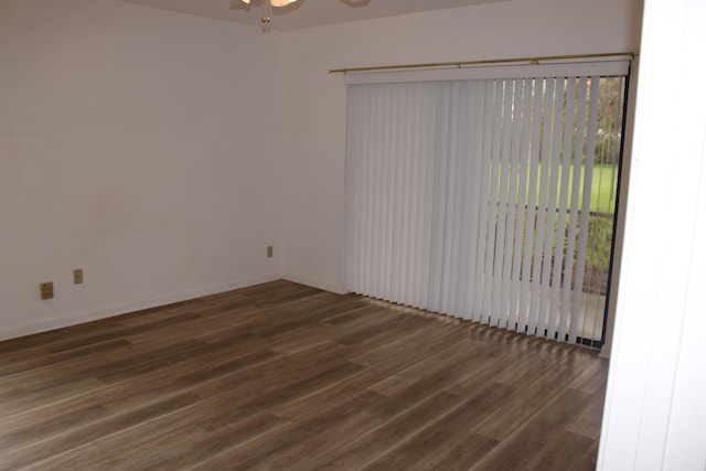 empty room featuring ceiling fan and dark wood-type flooring