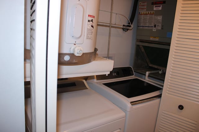 clothes washing area with washing machine and dryer and electric water heater