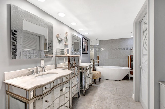 bathroom featuring vanity, tile walls, separate shower and tub, and tile patterned flooring