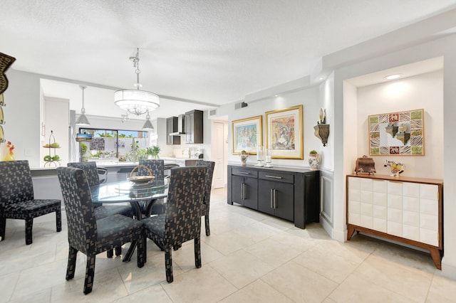 tiled dining space featuring a textured ceiling