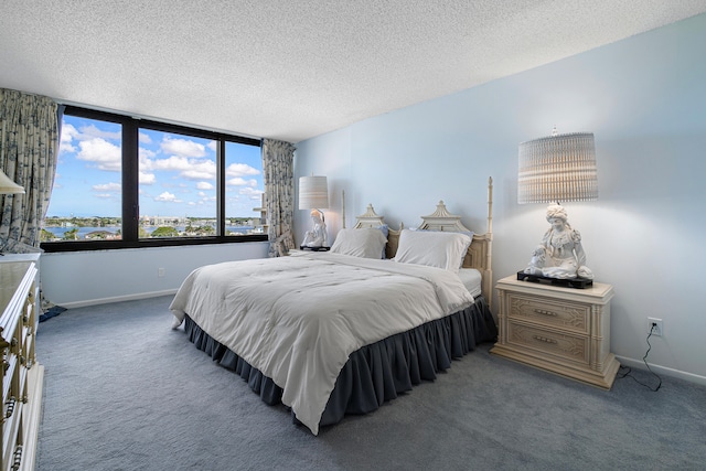 bedroom featuring a textured ceiling and carpet