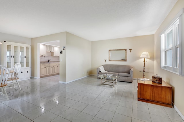 living room with light tile patterned floors and sink