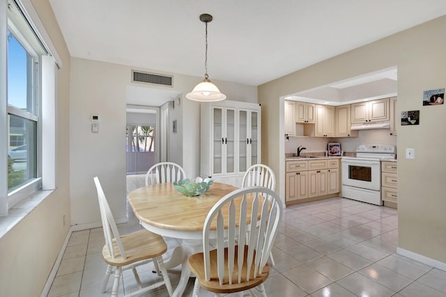 tiled dining space featuring sink