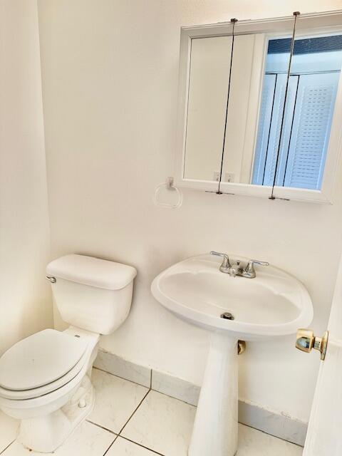 bathroom featuring tile patterned floors and toilet