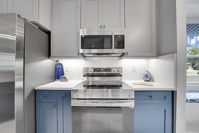 kitchen featuring tile patterned floors and appliances with stainless steel finishes