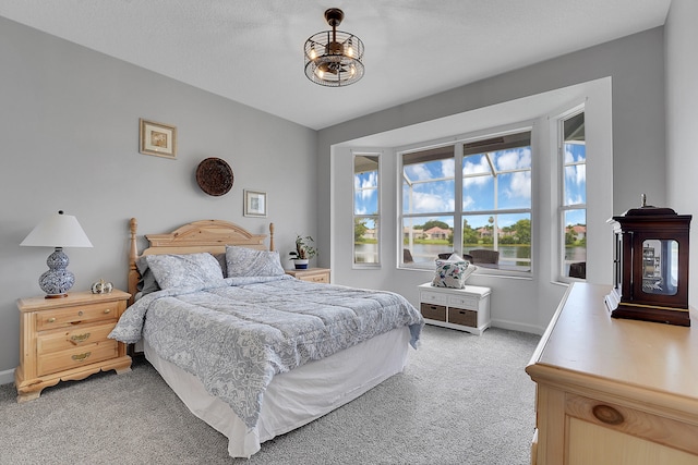 carpeted bedroom with a textured ceiling