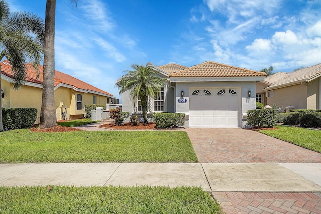 mediterranean / spanish-style house with a front lawn and a garage