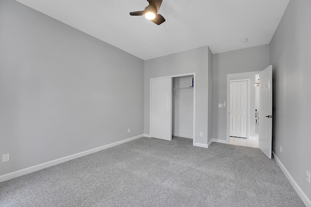 unfurnished bedroom featuring carpet floors, a closet, and ceiling fan