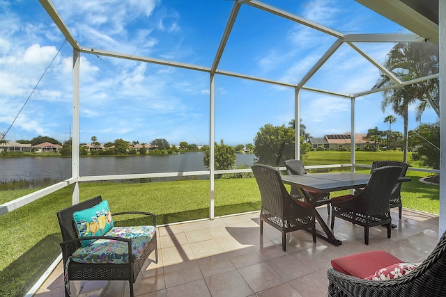 sunroom featuring a water view