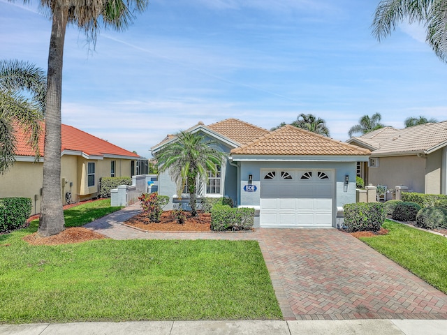 view of front of property featuring a garage and a front lawn