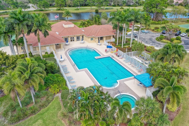 view of swimming pool with a water view and a patio