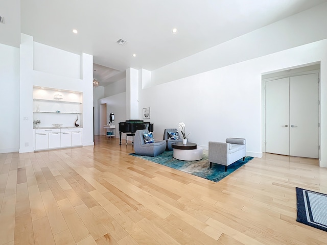 sitting room featuring light hardwood / wood-style floors and built in features