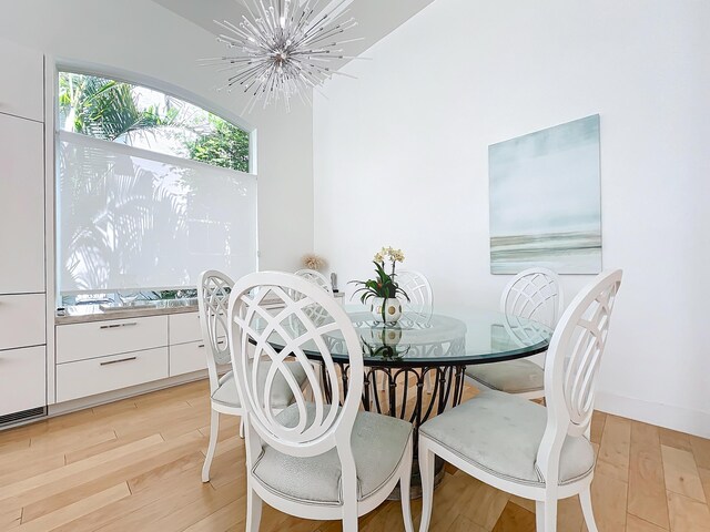 dining room featuring light hardwood / wood-style floors and a chandelier