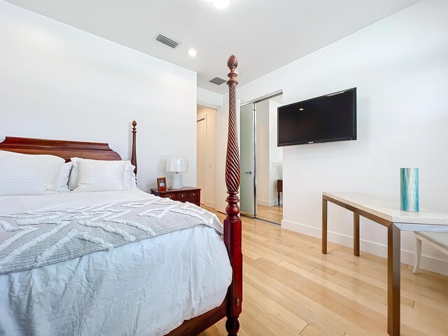 bedroom with a closet and light hardwood / wood-style floors