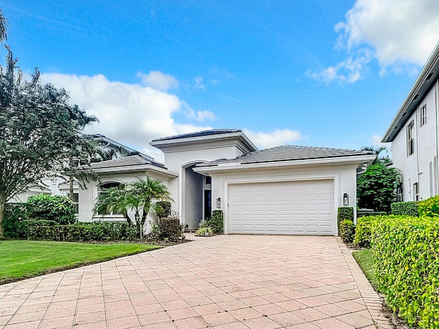 view of front facade with a garage and a front lawn