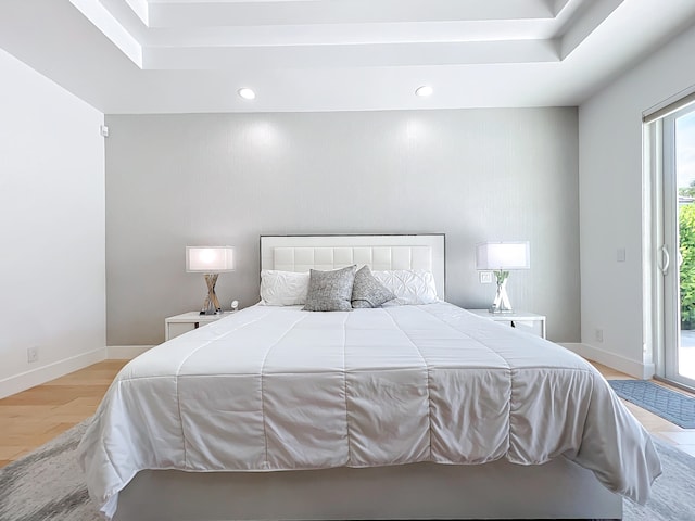 bedroom with light wood-type flooring and access to outside