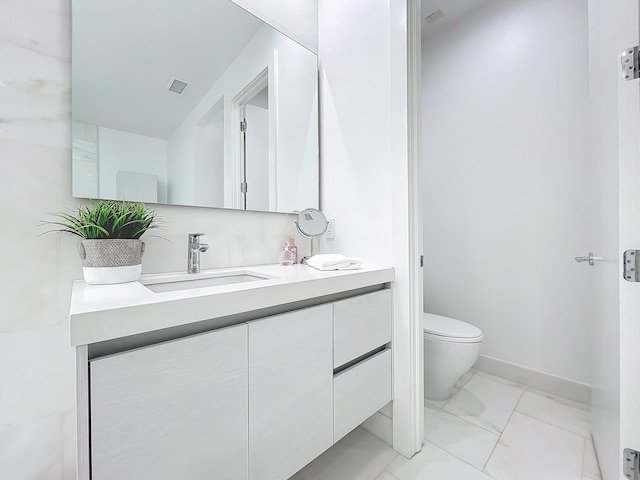 bathroom with vanity and toilet