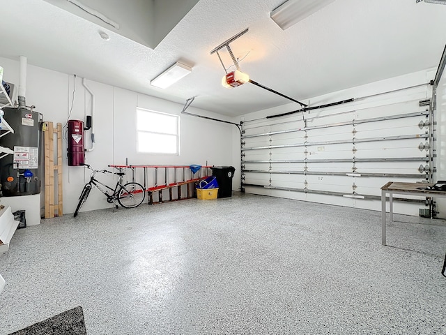 garage featuring water heater and a garage door opener