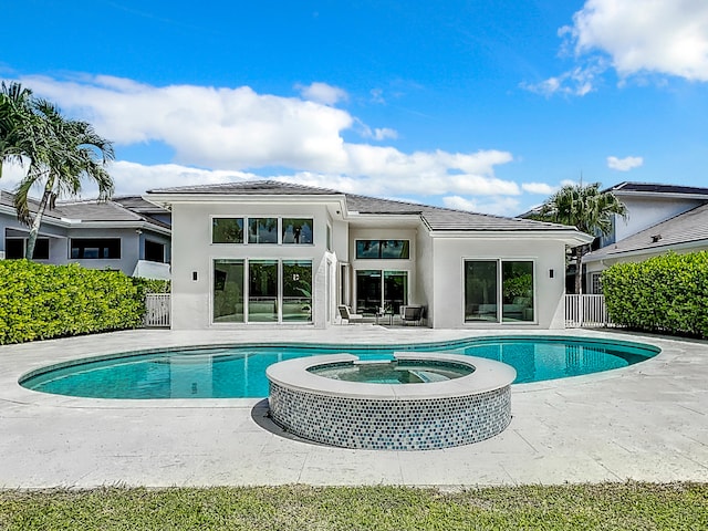 view of swimming pool featuring a patio and an in ground hot tub